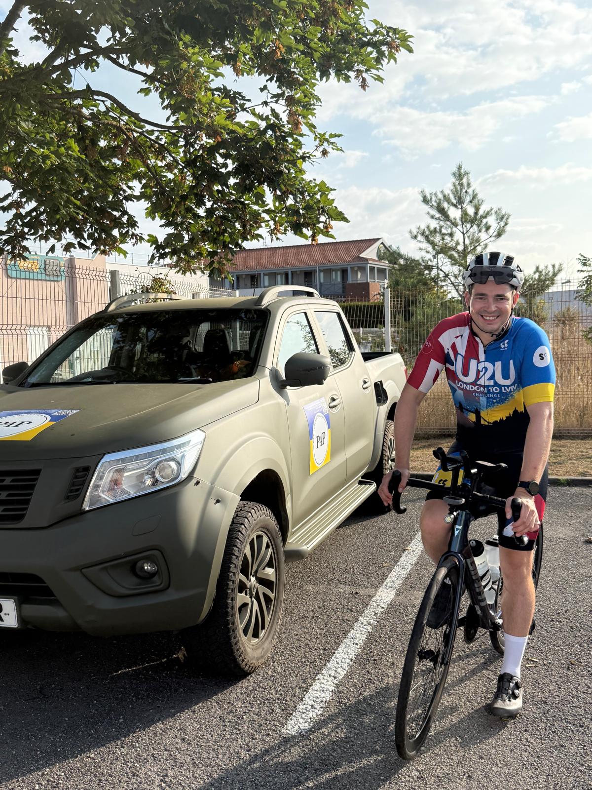 Matt with his bicycle beside the Pickups for Peace support vehicle at the start of Day 2